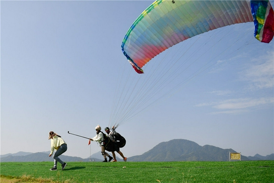 10月2日，游客在浙江省桐庐县钟山乡金家山滑翔伞基地体验滑翔伞。新华社记者 黄宗治 摄